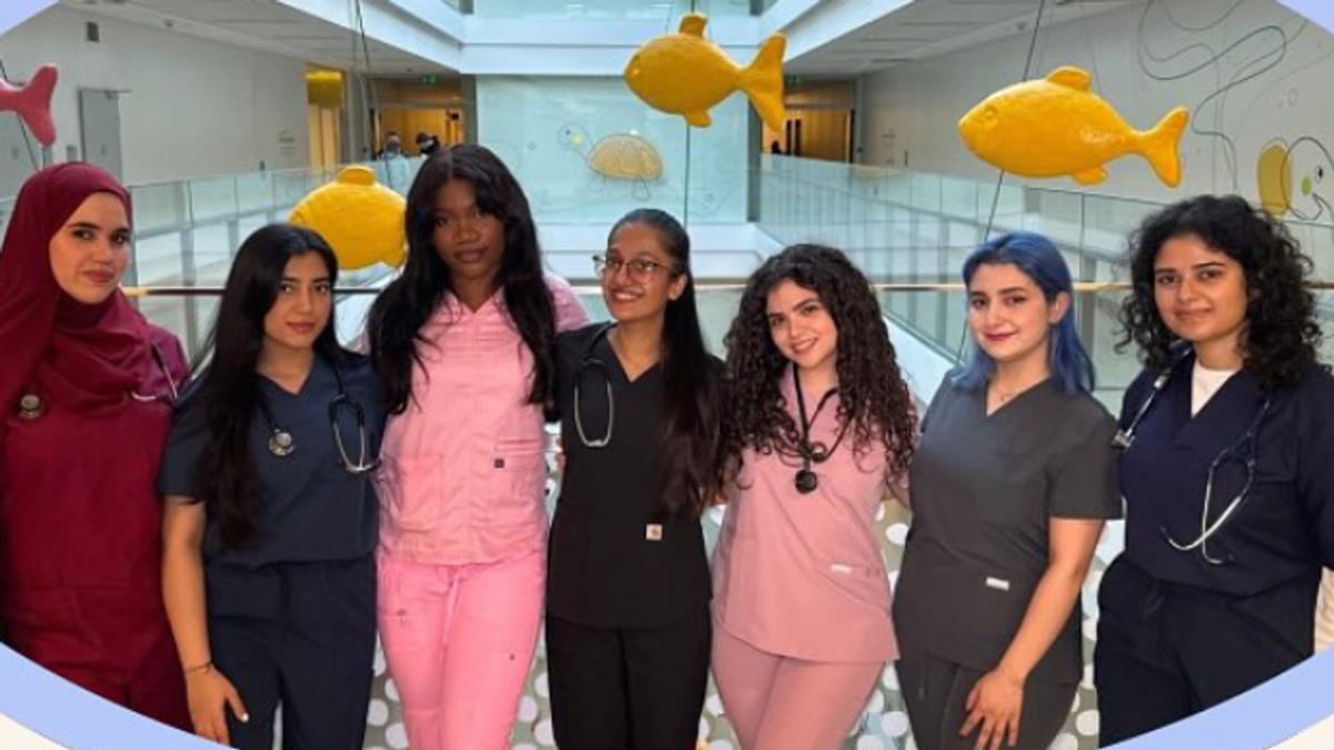 The 2026/27 OGMED board in scrubs on a hospital atrium walkway